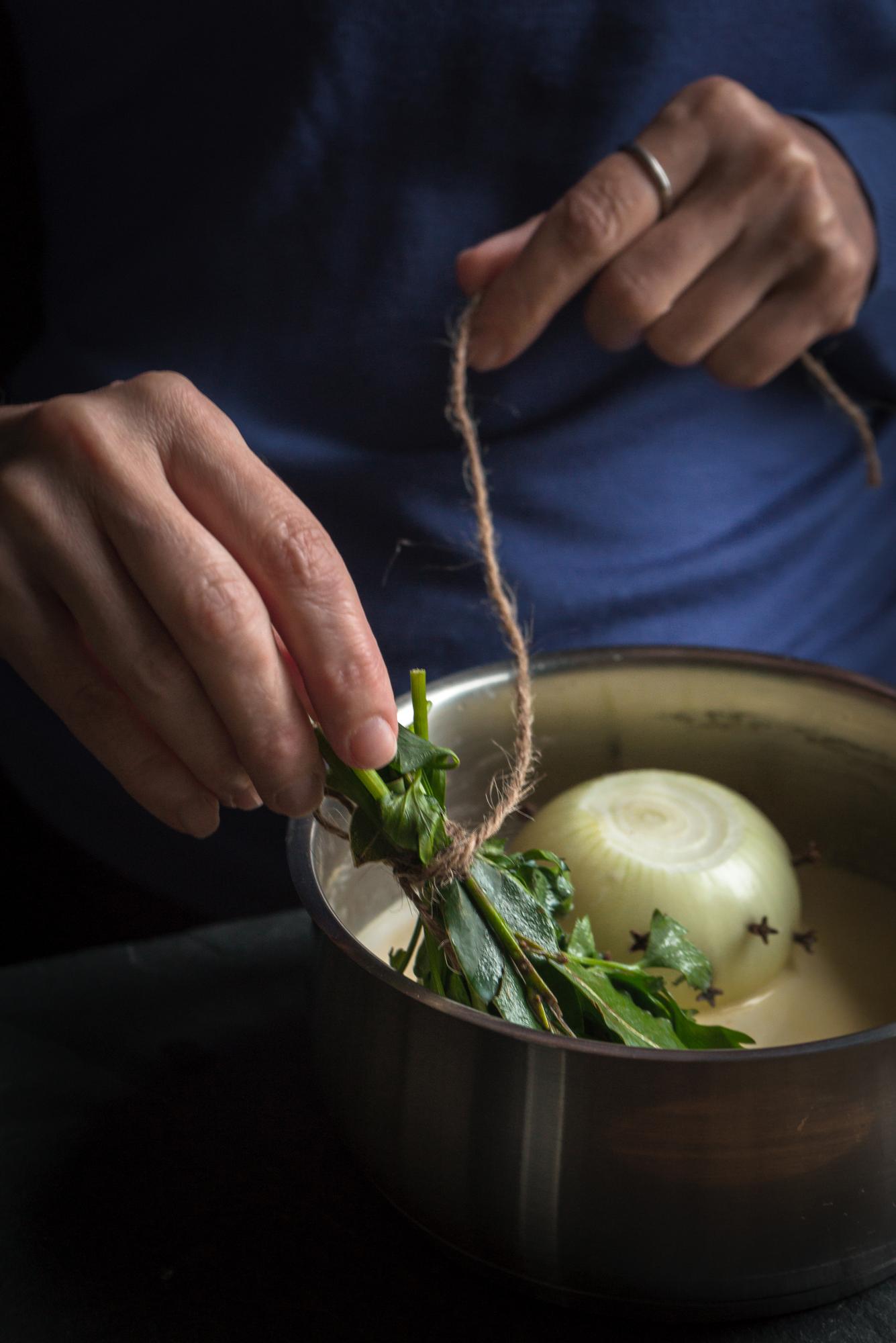 Chef arranging herbs on plate